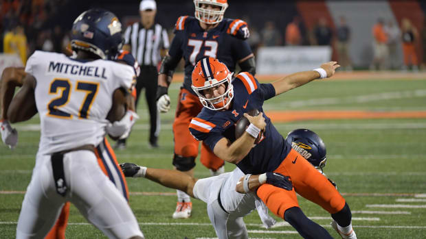 Sep 2, 2023; Champaign, Illinois, USA; Illinois Fighting Illini quarterback Luke Altmyer (9) runs the ball against the Toledo Rockets during the second half at Memorial Stadium.